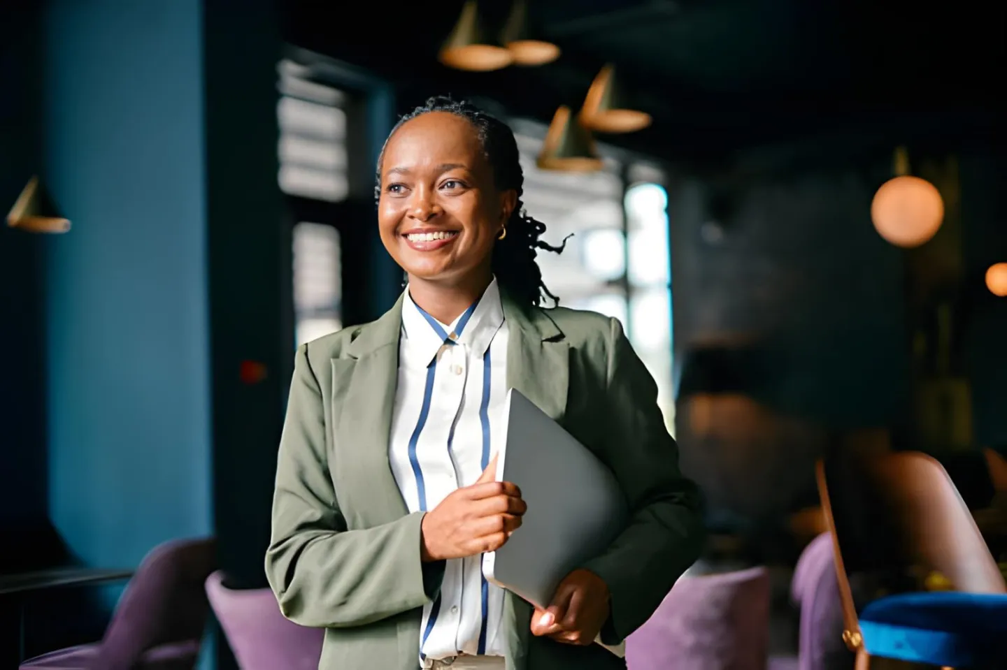 Confident businesswoman holding a laptop, a reseller ready to sell social media services