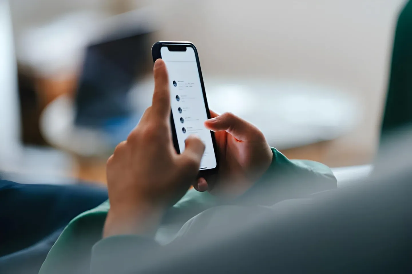 Hand holding a smartphone with an app open, showing how an SMM panel order is placed