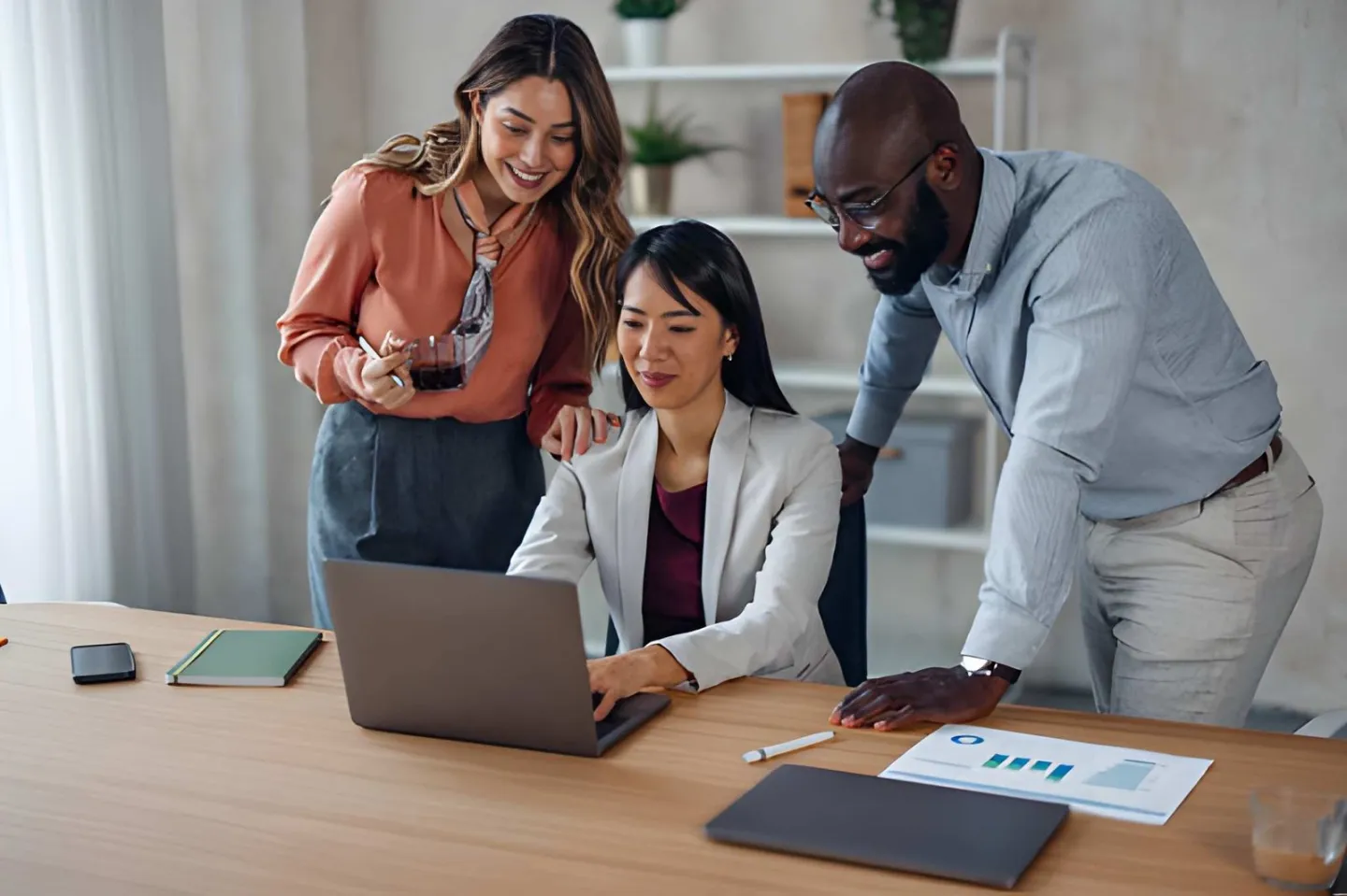 Team reviewing prices and margins together around a laptop