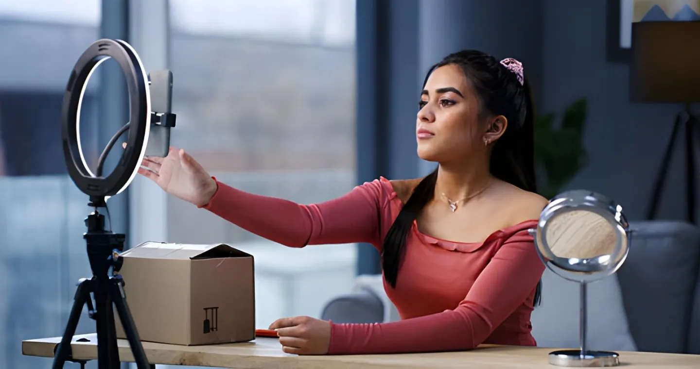 Woman setting up a ring light and phone to film content for her online shop